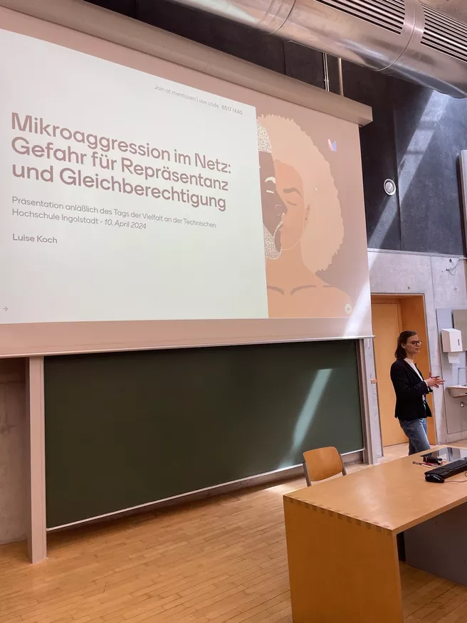 Luise Koch in front of a projector wall displaying her presentation