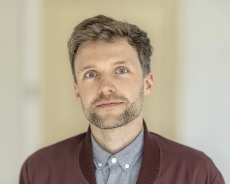 Philipp Stehr is looking straight ahead with a friendly smile